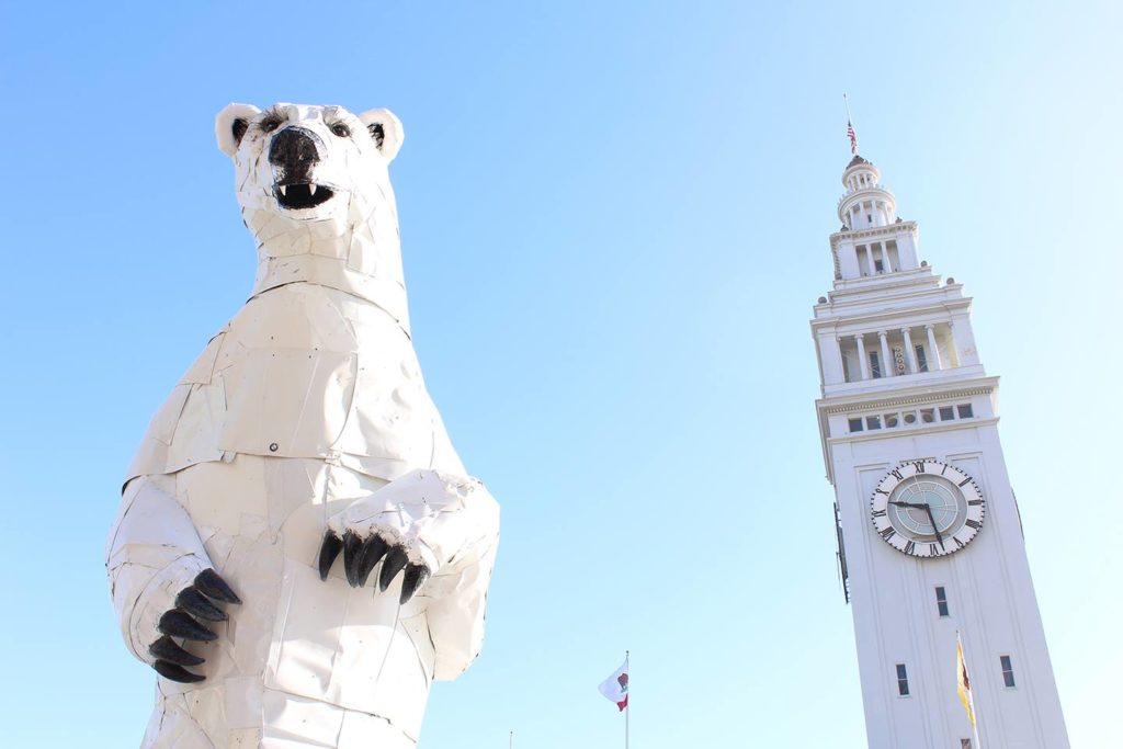 A 36' tall polar bear made from car hoods by artist Don Kennell named "Long View" hangs out with the SF Ferry Building